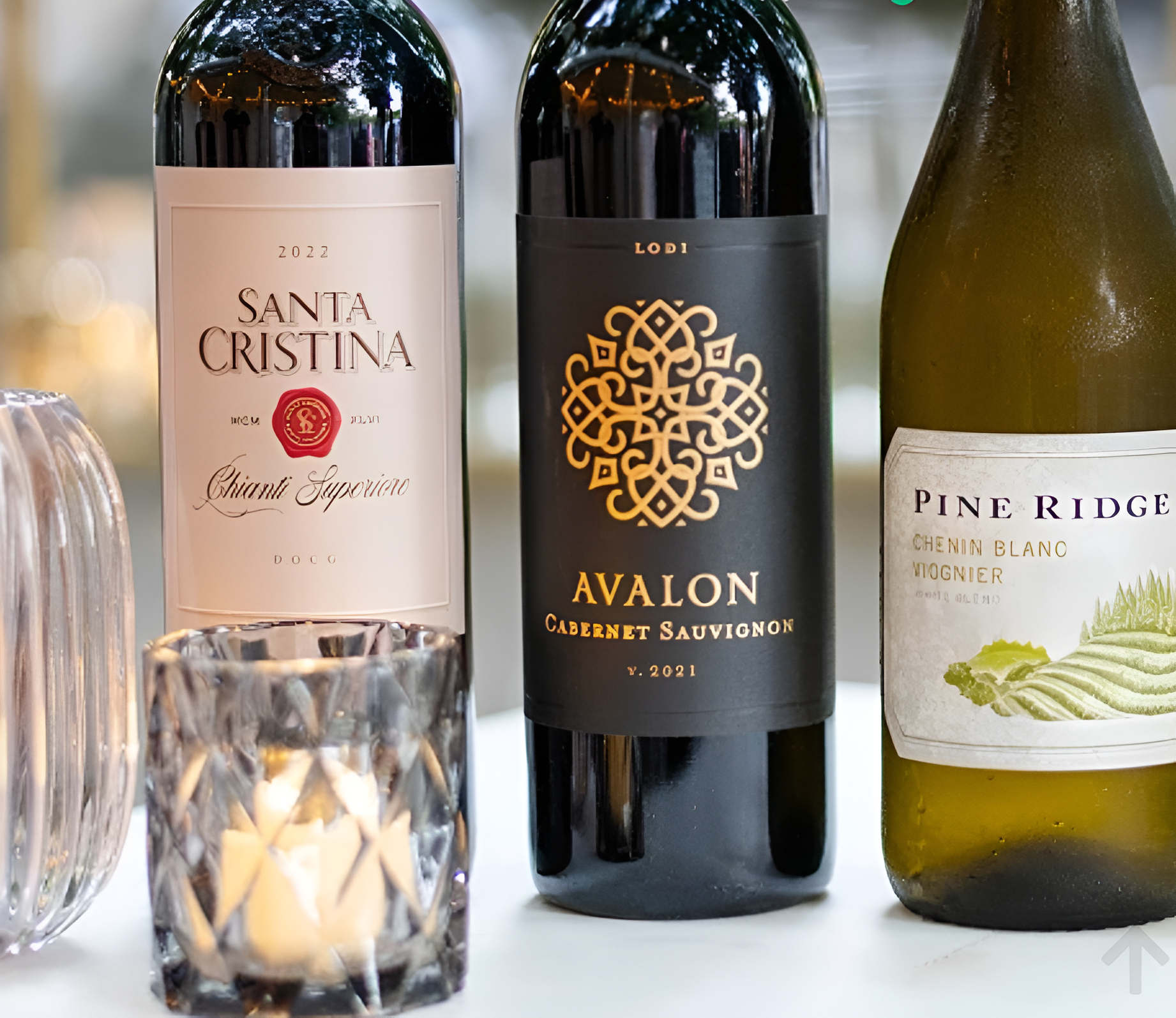 Wine selection display with candlelight at a JBCE catered event bar setup.