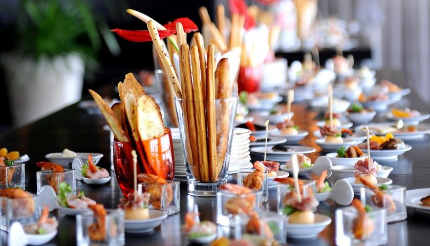 Assorted gourmet hors d’oeuvres and breadsticks elegantly arranged for a private event by Boston caterers.