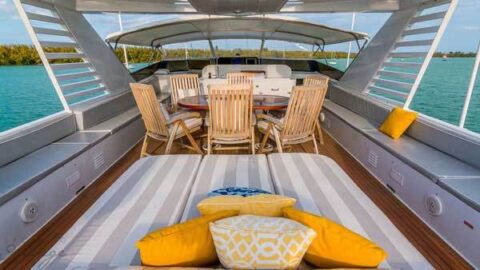 The luxurious outdoor deck on a yacht with comfortable seating and stunning water views.