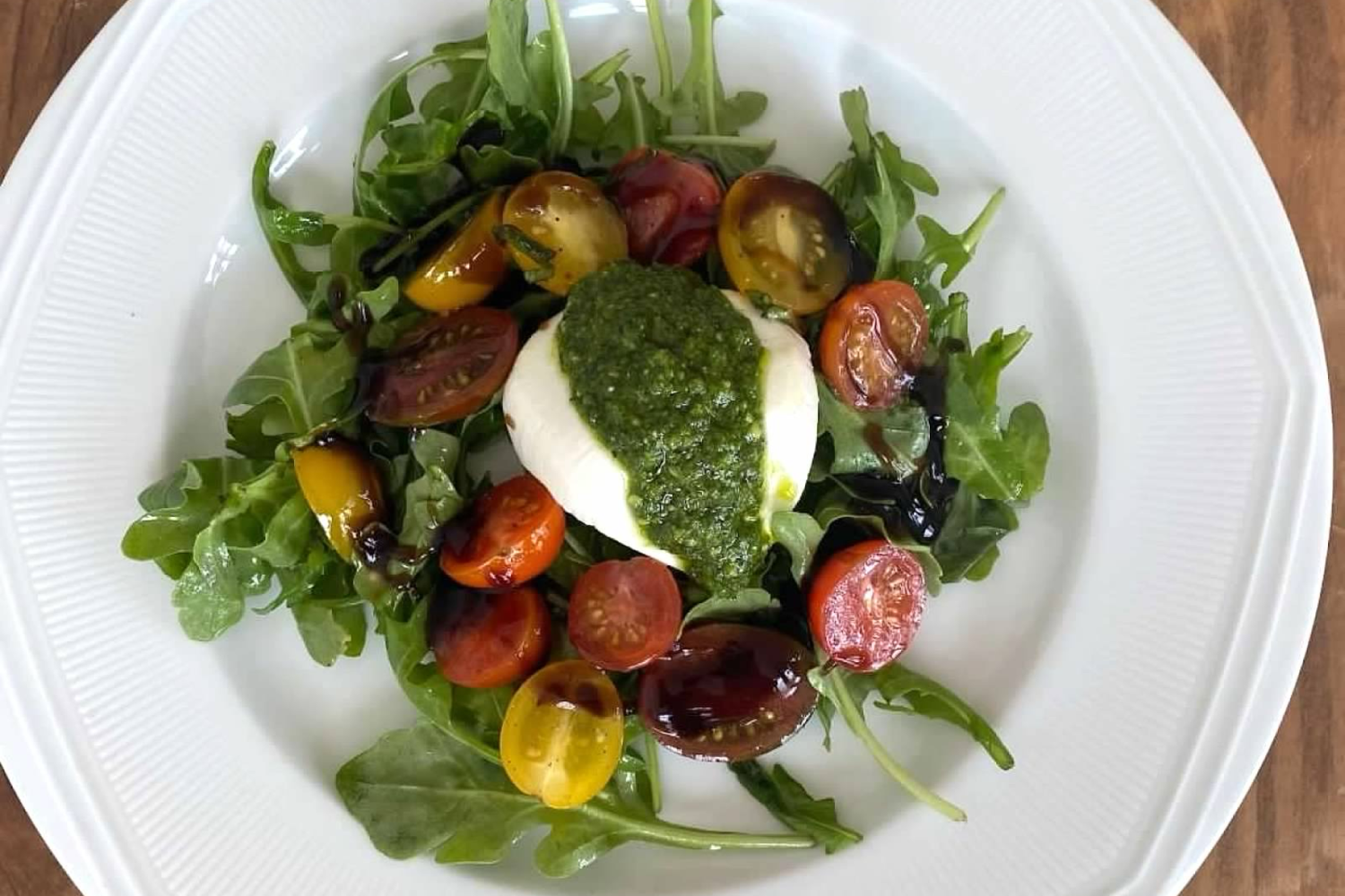 Heirloom tomato and burrata salad with fresh pesto, crafted for dietary-conscious catering in Boston.