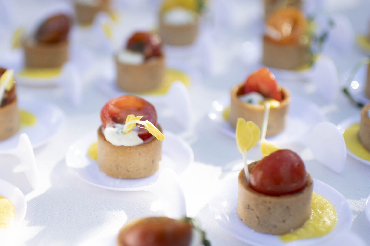 Heirloom Tomato & Whipped Ricotta Tartlet with Sienna Farms Corn Puree and Fresh Herbs, served at a rehearsal dinner.