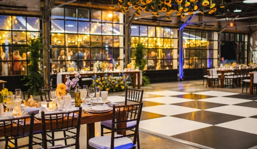 Event venue with candlelit tables and dance floor by Johnny Burke Catering & Events.